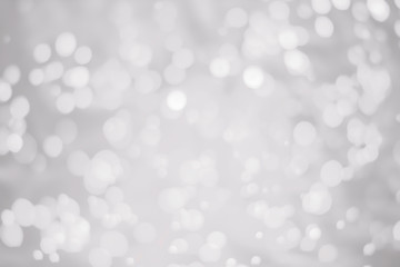White glitter vintage lights background. White bokeh on background.