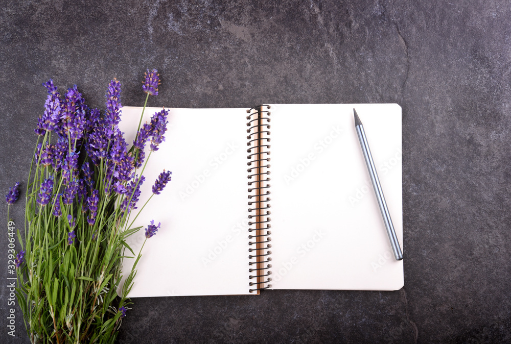 Poster mockup of open blank notepad and lavender bouquet