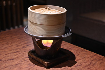 Bamboo steamer and cooking stove on the table