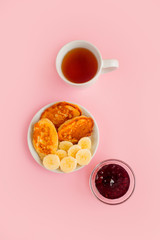 Pancakes with berries on a bright pastel background, copy space.