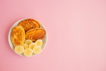 Pancakes with berries on a bright pastel background, copy space.