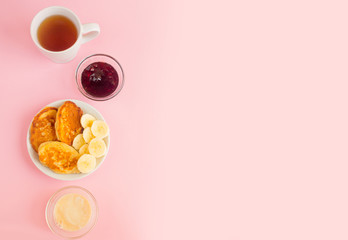 Pancakes with berries on a bright pastel background, copy space.