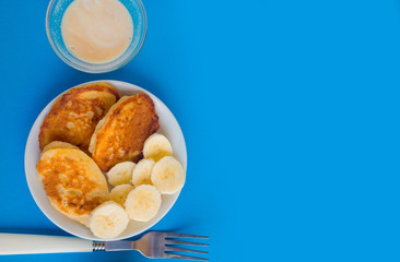 Pancakes with berries on a bright pastel background, copy space.