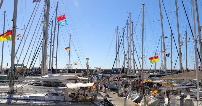 Port in Mogan where moored sport boats are moving in strong wind during a sunny day in the Gran Canary island 4k slow motion capture at 60fps.
