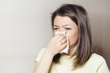 woman holds handkerchief, napkin in her hand. runny nose, common cold, virus