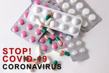 Coronavirus phrase text on a white background with medicines and pills. The concept of the new 2019 coronavirus nCoV. MERS-Cov Middle East Respiratory Syndrome Coronavirus.