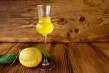 Glass limoncello liqueur and lemon