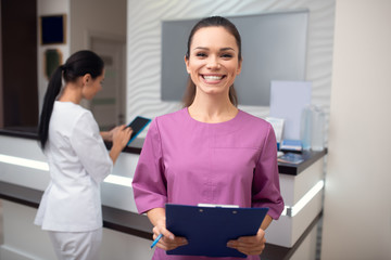 Beaming woman working in beauty clinic smiling broadly
