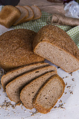 Whole- grain rye bread on a tree with wheat grains. Dietary product of proper nutrition
