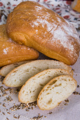 Whole-grain ciabatta bread on a tree with wheat grains. Dietary product of proper nutrition