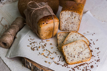 Whole- grain fresh bread on a tree with wheat grains. Dietary product of proper nutrition