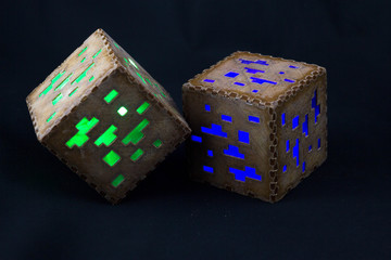 Minecraft cubes made of plastic. Two brown minecraft cubes with glowing Windows