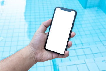 Asian man holding phone mock up right frame at pool outdoor have isolated display for insert screen