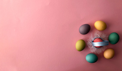 Template greeting card, copy Space for the holiday Easter eggs colorful on a pink background