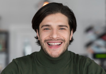 Portrait of cheerful attractive man in good mood having rest