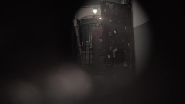 Dark prison corridor through a hole, old walls, scary