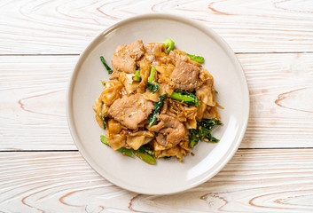 Stir-fried rice noodle with black soy sauce and pork and kale © topntp