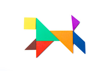 Fototapeta na wymiar Color wood tangram puzzle in dog shape on white background