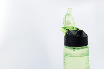 Closeup of opened sport bottle full of cold water against bright background