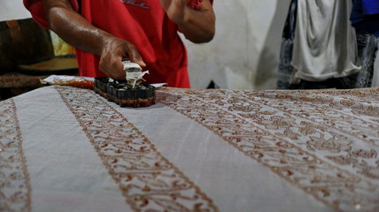 Activity of making batik,  Create and design white fabric using canting and malam by slamming over...