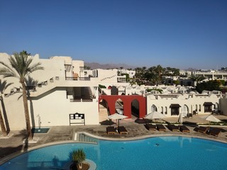 arabic hotel buildings with palm trees