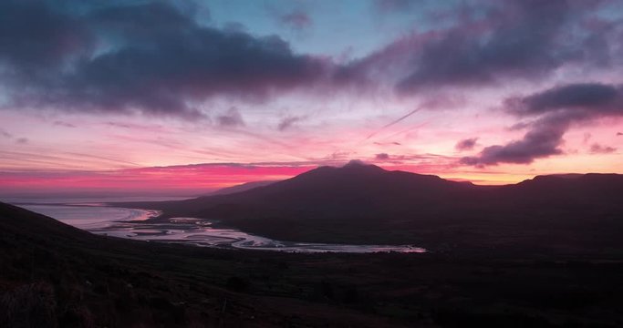 Breathtaking and spectacular 4K video of sunrise in Brandon Bay with moving clouds and fiery colors, Dingle Peninsula, Ireland
