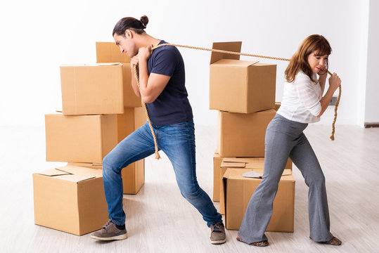 Young Pair And Many Boxes In Divorce Settlement Concept