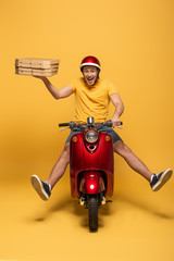 happy delivery man in yellow uniform riding scooter with pizza boxes on yellow background