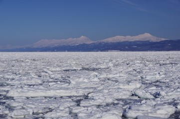 Shiretoko, winter landscape with mountain range and ice floe in Hokkaido,...