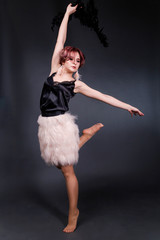 Beautiful retro woman from the roaring 20s is dancing on black background