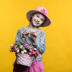 Little smile girl with flowers in basket.