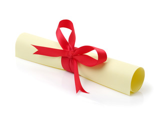 Diploma, close up of paper scroll with red ribbon isolated on white 