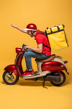 side view of delivery man with backpack on scooter on yellow background