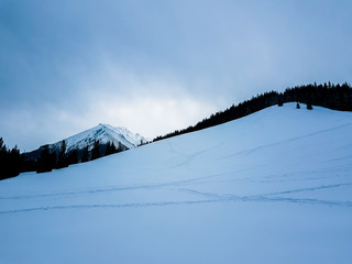 Snow- covered valley and mountain, gloomy sky © Bogdan