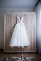 Fototapeta na wymiar bride wedding dress hanging on the closet