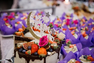 Naklejka na ściany i meble wedding cake with a candy bar in a restaurant