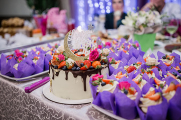 Naklejka na ściany i meble wedding cake with a candy bar in a restaurant