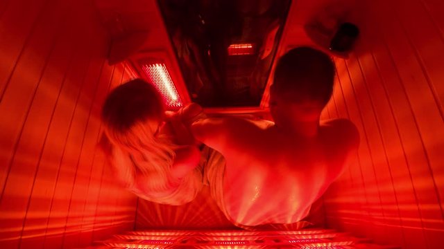 Happy couple relaxing in a luxury infrared sauna - Motion blurr