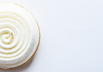 Beautiful vanilla tartlet with soft mascarpone cream and gold on top. Isolated. Copy space. Top view. 