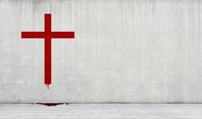 Catholic cross drawn in red paint on the wall.