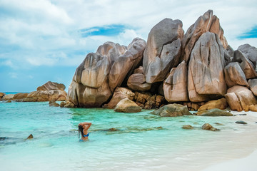 La Digue Seychelles,young woman in casual clothes on the beach at Anse Source d'Argent, LA Digue...