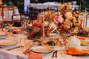 tables in outdoor tent evening. Wedding decor.