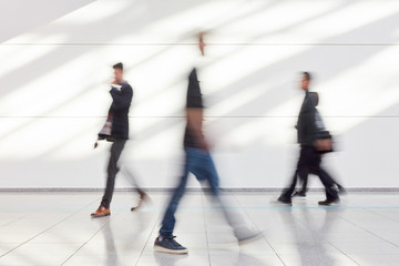 Anonymous business people go in office or trade fair