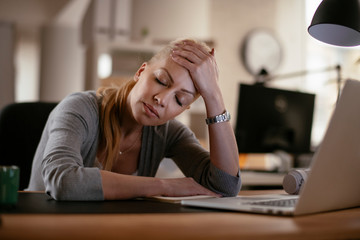 Beautiful businesswoman falling asleep. Tired businesswoman in office.	