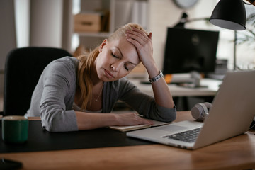 Beautiful businesswoman falling asleep. Tired businesswoman in office.