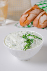 Greek appetizer (salad) - tzatziki. Yogurt, fresh cucumbers and dark (buckwheat) bread (baguette).
