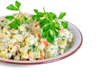 The vinaigrette of various boiled vegetables in the plate on white