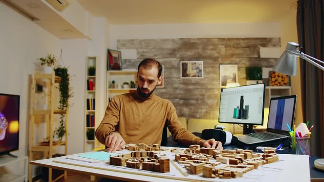 Architect working in augmented reality placing skyscrapers in historic part of the city