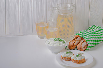 Greek appetizer (salad) - tzatziki. Yogurt, fresh cucumbers and dark (buckwheat) bread (baguette).