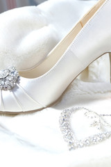 Wedding decor, high-heeled shoes and women's jewelry. White soft coat